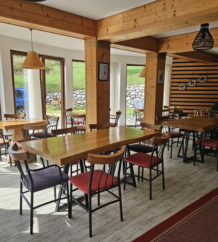Wooden dining room and lounge with a hanging fireplace