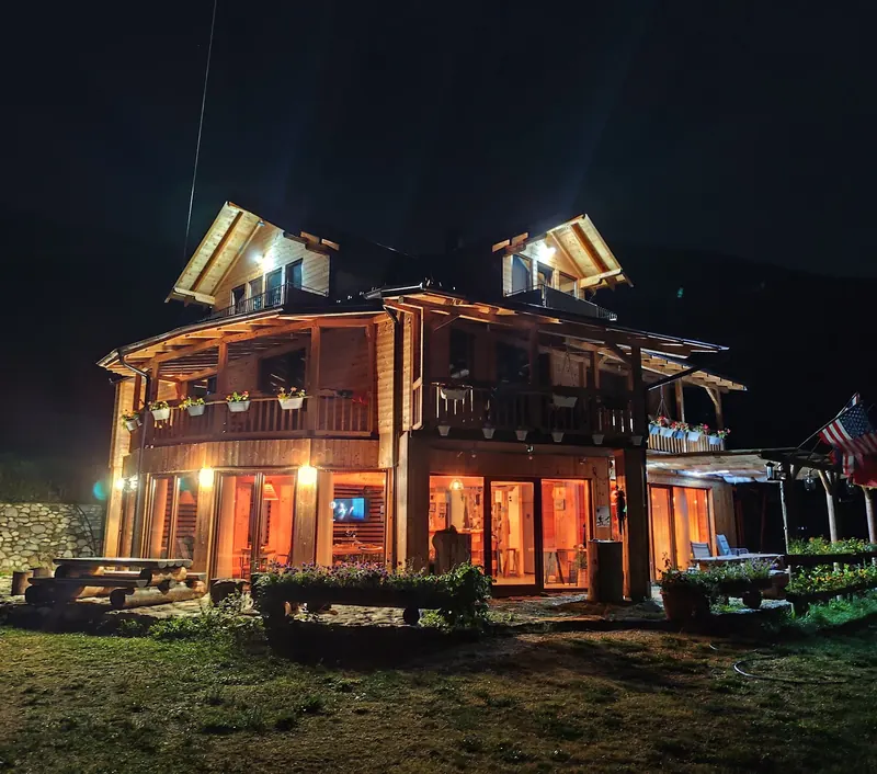 The guesthouse lit up at night