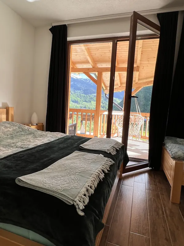 Bedroom with the balcony door open to the valley